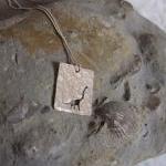 Silver Dinosaur pendant: A ..