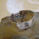 Silver textured bracelet wi..