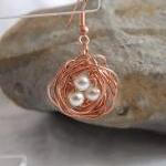 Copper nest earrings: A cute pair of earrings made from copper wire and white pearl beads.