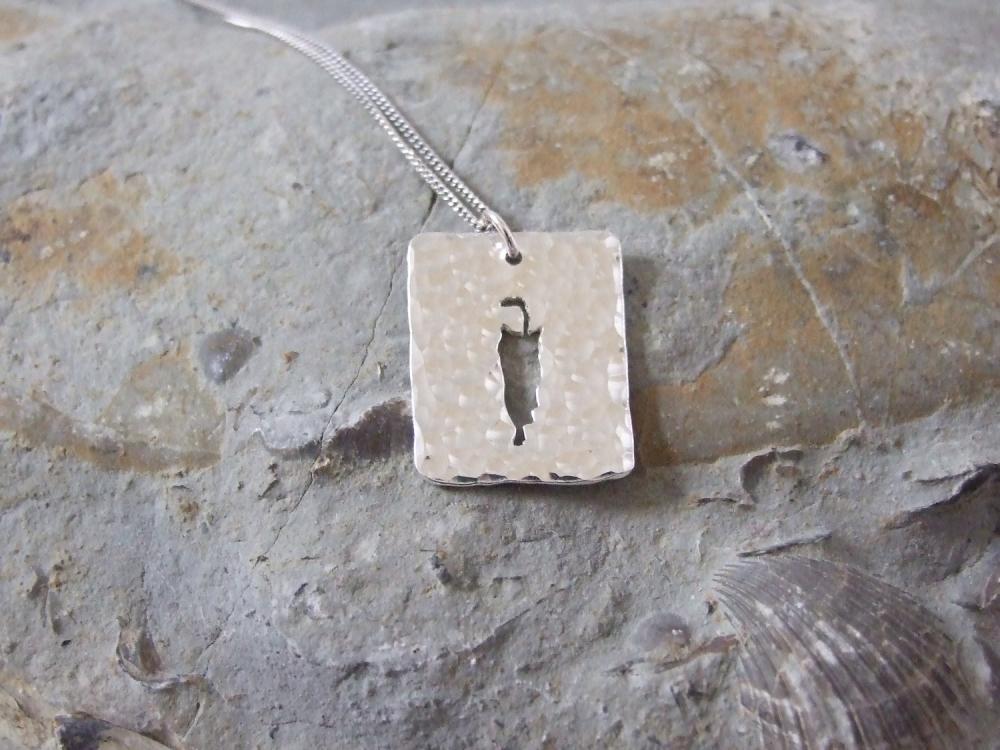 Stalking cat pendant: A cat stalks its prey on a background of textured sterling silver.